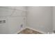 Efficient laundry room with tile flooring, utility connections, and shelving for storage at 319 Garden Grove St, Conway, SC 29526