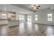 Open-concept living and kitchen area featuring modern flooring, natural light and neutral paint at 319 Garden Grove St, Conway, SC 29526