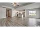 Open-concept living space with wood-look floors, recessed lighting, and a modern kitchen with an island at 319 Garden Grove St, Conway, SC 29526