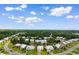 Aerial view of home at 323 Waties Dr, surrounded by lush greenery and a tranquil pond at 323 Waties Dr., Murrells Inlet, SC 29576