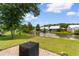 Scenic backyard view featuring a community pond with fountain, lush grass, and well-kept landscaping at 323 Waties Dr., Murrells Inlet, SC 29576