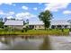 Back of house view on community pond showing screen porch and metal roof at 323 Waties Dr., Murrells Inlet, SC 29576