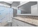 Well-lit bathroom featuring a granite countertop, decorative shower curtain, and neutral gray wall paint at 323 Waties Dr., Murrells Inlet, SC 29576