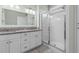Bathroom featuring double sink vanity with granite countertop and glass-enclosed shower at 323 Waties Dr., Murrells Inlet, SC 29576