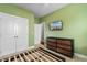 Green bedroom with closet, dresser, and neutral carpet at 323 Waties Dr., Murrells Inlet, SC 29576