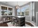 Bright dining area featuring a modern chandelier, ample natural light, and a stylish table set at 323 Waties Dr., Murrells Inlet, SC 29576