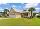 Charming yellow home featuring a metal roof, a welcoming front porch, and a well-manicured lawn at 323 Waties Dr., Murrells Inlet, SC 29576