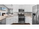 Modern kitchen featuring stainless steel appliances, granite countertops, and white cabinetry at 323 Waties Dr., Murrells Inlet, SC 29576