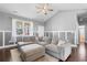 Spacious living room with a plush sectional sofa, hardwood floors, and ample natural light at 323 Waties Dr., Murrells Inlet, SC 29576