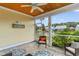 Inviting screened porch with wood ceiling overlooks a tranquil pond and well-maintained landscaping at 323 Waties Dr., Murrells Inlet, SC 29576