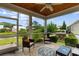 Relaxing screened porch with an outdoor ceiling fan offers lovely views of the community pond at 323 Waties Dr., Murrells Inlet, SC 29576