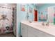 Bright bathroom with double sinks, modern white cabinets, and a charming underwater-themed shower curtain at 348 Hidden Cove Dr., Little River, SC 29566
