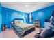 Bright blue bedroom featuring a decorative headboard, nautical-themed bedding, and a sunlit window at 348 Hidden Cove Dr., Little River, SC 29566