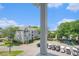 Exterior view of the building, showing parking for golf carts and landscaping at 351 Lake Arrowhead Rd. # 24-396, Myrtle Beach, SC 29572
