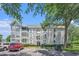 Well-maintained condo building with neatly landscaped grounds and convenient parking spaces under a clear blue sky at 351 Lake Arrowhead Rd. # 24-396, Myrtle Beach, SC 29572