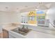 Kitchen with stainless steel appliances and sleek countertops, opens to a sunny living room with vaulted ceilings at 351 Lake Arrowhead Rd. # 24-396, Myrtle Beach, SC 29572