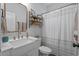 Bright bathroom featuring white fixtures, a modern sink, and a decorative mirror and shelf at 3620 Diamond Stars Way, Little River, SC 29566