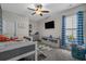 Charming bedroom features neutral walls, a modern tv, built in storage, and a window with plenty of light at 3620 Diamond Stars Way, Little River, SC 29566