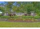 Beautifully landscaped community entrance with stone signage and vibrant flower beds at 3620 Diamond Stars Way, Little River, SC 29566