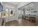 Bright dining room with wainscoting, stylish lighting, and a view of the front yard at 3620 Diamond Stars Way, Little River, SC 29566