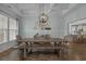 Elegant dining area with a farmhouse table, coffered ceiling, and decorative wall art at 3620 Diamond Stars Way, Little River, SC 29566