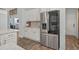 Close-up of a bright kitchen featuring stainless steel appliances and hardwood floors at 3620 Diamond Stars Way, Little River, SC 29566