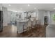 Open-concept kitchen with a large island, breakfast bar, and hardwood floors throughout the room at 3620 Diamond Stars Way, Little River, SC 29566