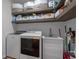 Laundry room features a washer, dryer, and sink with storage shelving and ample space for organization at 3620 Diamond Stars Way, Little River, SC 29566