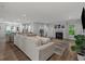 Spacious living area with a fireplace, modern furniture, and seamless flow into the kitchen and dining area at 3620 Diamond Stars Way, Little River, SC 29566