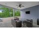 Outdoor patio with comfortable seating, ceiling fan, and mounted television for relaxing and entertaining at 3620 Diamond Stars Way, Little River, SC 29566