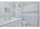 Bathroom with a combined shower and tub, a light gray shower curtain, and a vanity at 404 1St Ave. N # H, North Myrtle Beach, SC 29582