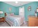 Cozy bedroom with cheerful blue walls, flamingo art, and comfortable furnishings at 404 1St Ave. N # H, North Myrtle Beach, SC 29582
