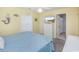 Cozy bedroom featuring a queen bed, beach themed decor and an adjoining bathroom at 404 1St Ave. N # H, North Myrtle Beach, SC 29582