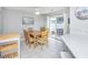 Dining area featuring a wooden table with seating and a sliding glass door at 404 1St Ave. N # H, North Myrtle Beach, SC 29582