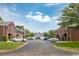 View of well-maintained townhome exteriors with black awnings, parking area, and green landscaping at 404 1St Ave. N # H, North Myrtle Beach, SC 29582