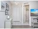 Hallway with a Main Street sign, storage closet, and open view to a half bathroom at 404 1St Ave. N # H, North Myrtle Beach, SC 29582