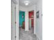 Hallway view leading to bedrooms with colorful accent walls and neutral carpeting at 404 1St Ave. N # H, North Myrtle Beach, SC 29582