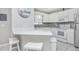 Bright kitchen with white cabinets, modern appliances, and a counter with barstool seating at 404 1St Ave. N # H, North Myrtle Beach, SC 29582