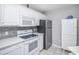 Bright kitchen featuring stainless steel appliances, quartz countertops, and white cabinets at 404 1St Ave. N # H, North Myrtle Beach, SC 29582