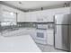 Bright kitchen with stainless steel appliances, white cabinets, and stone backsplash at 404 1St Ave. N # H, North Myrtle Beach, SC 29582
