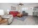 Cozy living room featuring a wood floor, a ceiling fan, and comfortable seating at 404 1St Ave. N # H, North Myrtle Beach, SC 29582