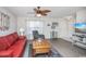 Inviting living room featuring a ceiling fan, wood flooring, and comfortable seating arrangement at 404 1St Ave. N # H, North Myrtle Beach, SC 29582