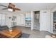 Bright living room boasts wood floors, ceiling fan, and staircase access to the upper level at 404 1St Ave. N # H, North Myrtle Beach, SC 29582