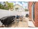 Private brick patio with grill, outdoor furniture, and vinyl fencing in this cozy backyard at 404 1St Ave. N # H, North Myrtle Beach, SC 29582
