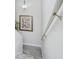 Carpeted staircase with a white handrail and framed artwork on the light gray wall at 404 1St Ave. N # H, North Myrtle Beach, SC 29582