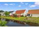 Backyard with a pond view, a deck, and lush landscaping at 425 Mallard Lake Circle, Surfside Beach, SC 29575
