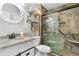 Bathroom featuring a shower with decorative tile, granite countertop, and oval mirror at 425 Mallard Lake Circle, Surfside Beach, SC 29575