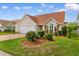 Charming single-story home with a well-manicured lawn and red painted driveway at 425 Mallard Lake Circle, Surfside Beach, SC 29575