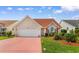 Charming home featuring a red-colored driveway, attached garage, and manicured landscaping at 425 Mallard Lake Circle, Surfside Beach, SC 29575