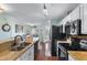 Open concept kitchen with stainless steel appliances, granite countertops and hardwood floors at 425 Mallard Lake Circle, Surfside Beach, SC 29575